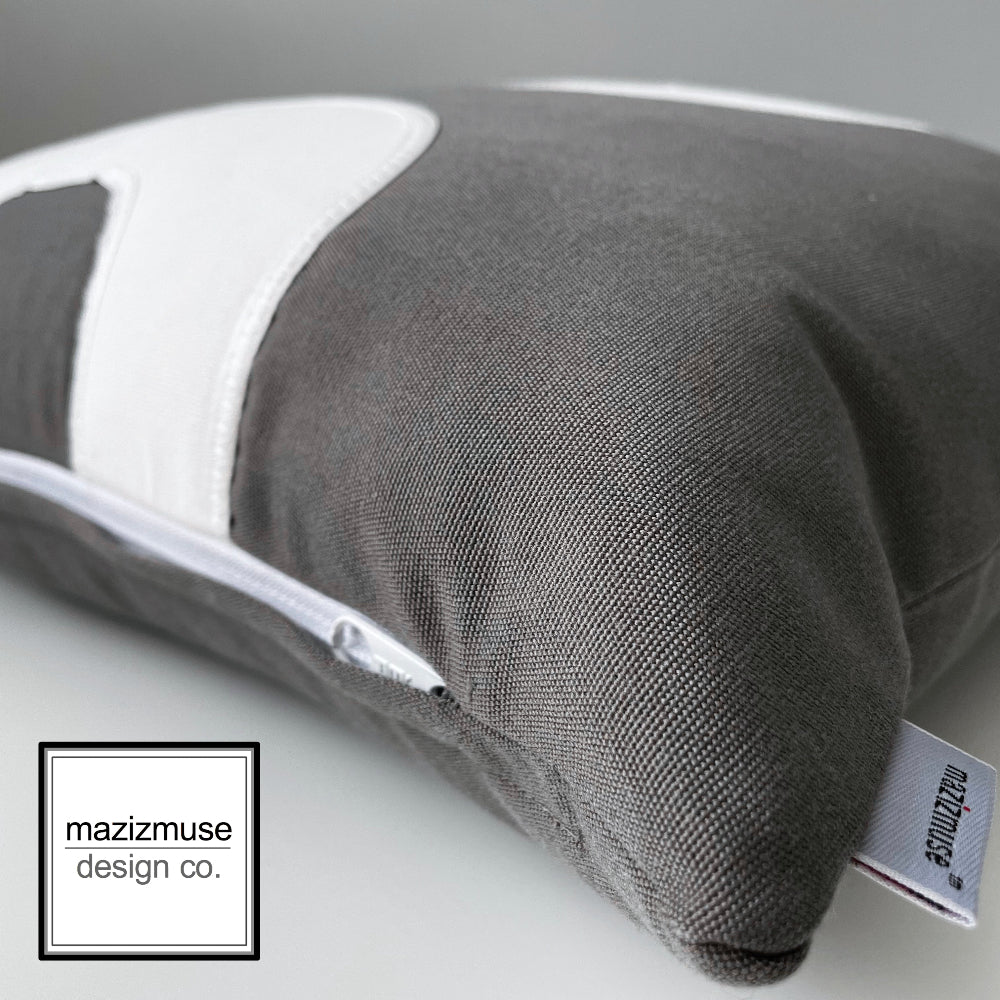 grey and white sunbella outdoor pillow showing zipper detail and mazizmuse logo