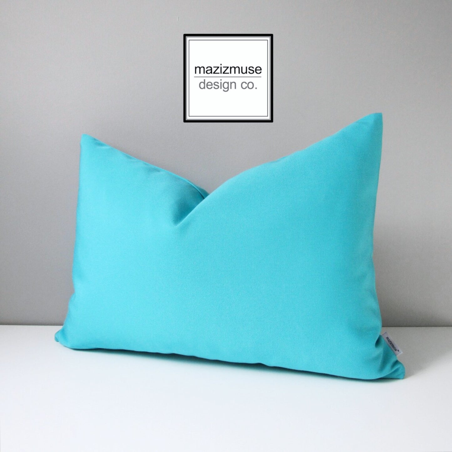 solid arube blue sunbrella outdoor pillow in bright turquoise for patio and pool eating