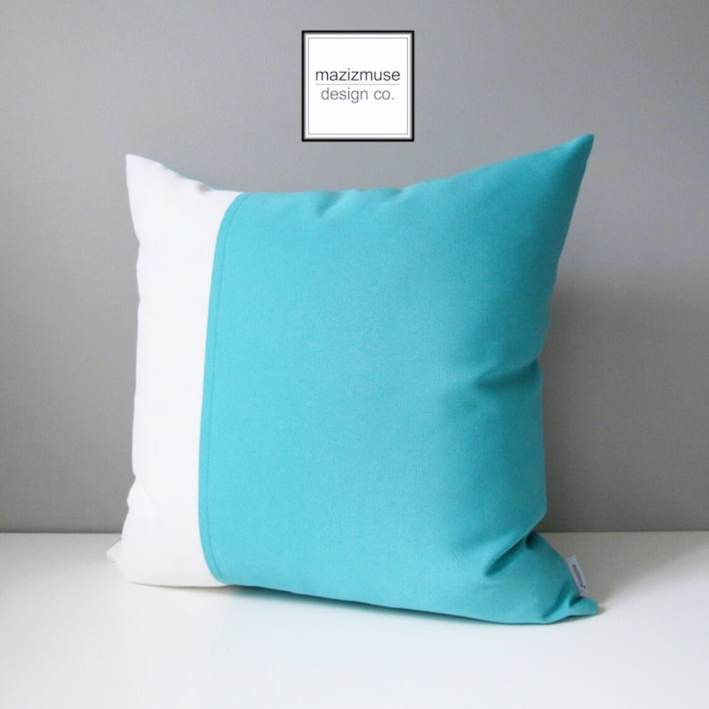 decorative aruba blue and white sunbrella outdoor pillow in modern colorblock design by mazizmuse