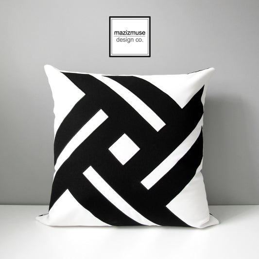 white and black geometric outdoor sunbella pillow cover with striking pinwheel design