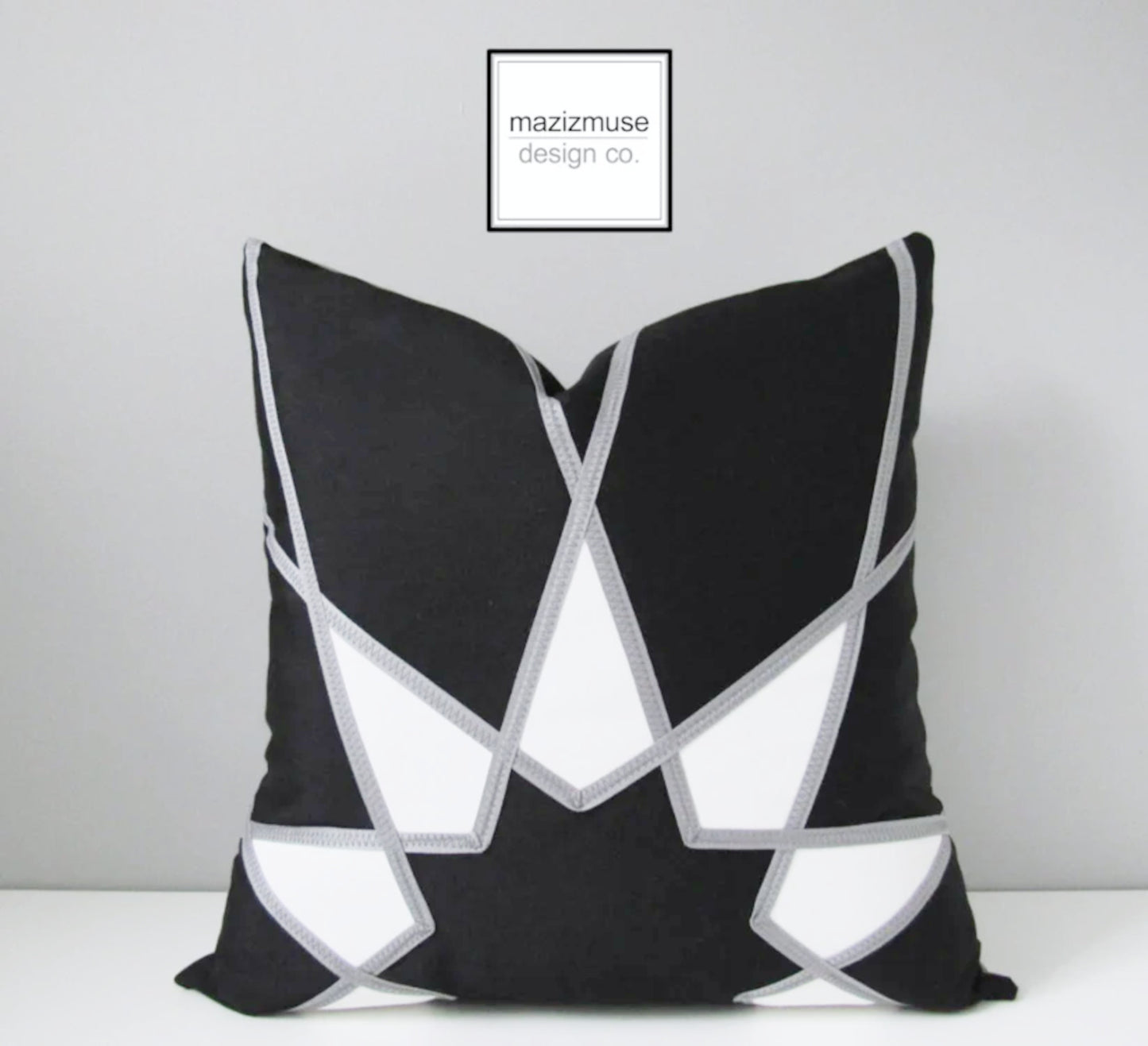 decorative black and white outdoor pillow crafted in sunbrella fabric and grey trim detail by mazizmuse