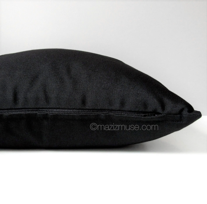 solid black sunbrella outdoor pillow showing zipper detail