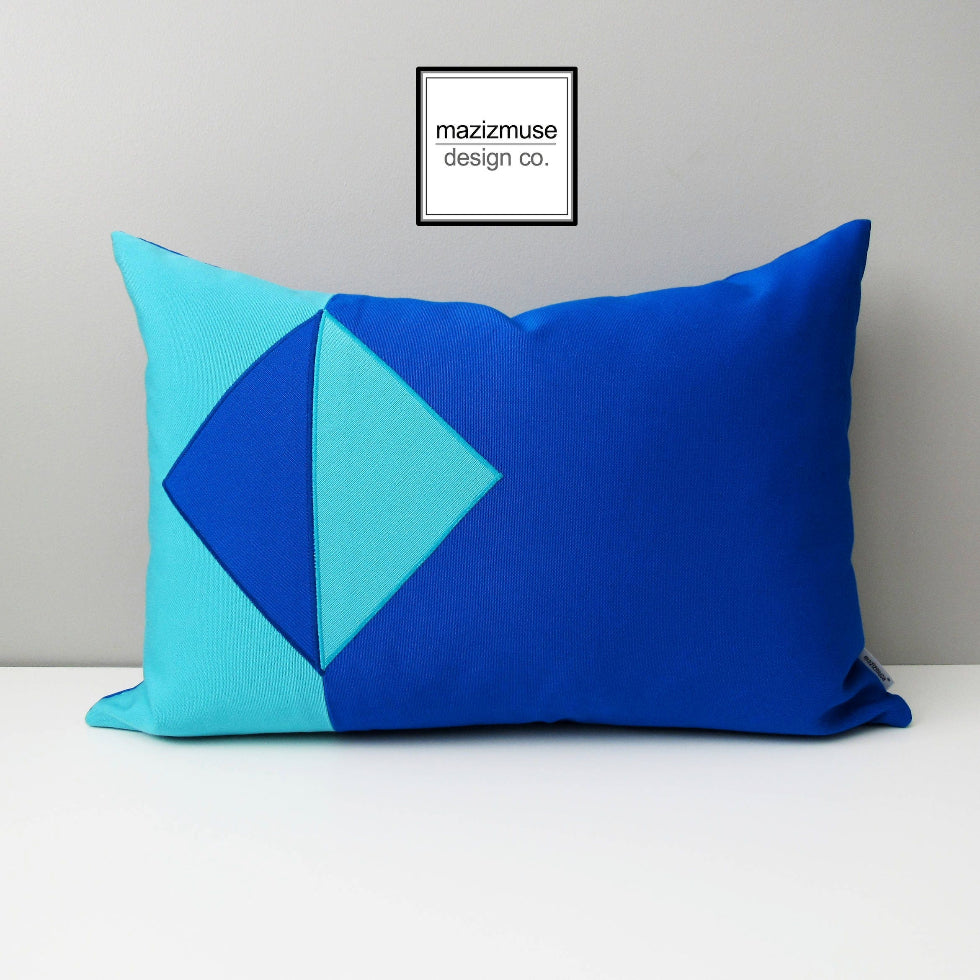 outdoor pillow in two shades of sunbrella blues - aruba and pacific. a simplistic geometric design ideal for modern patio accents