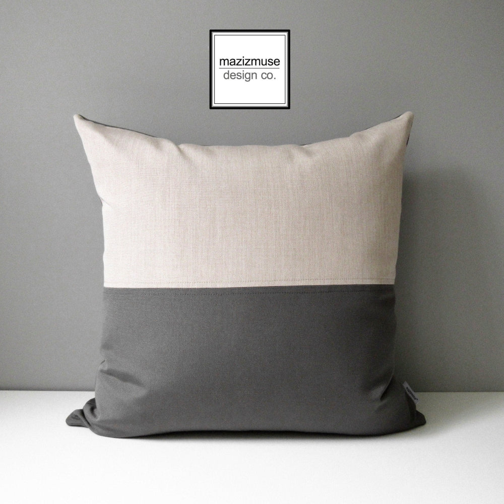 charcoal grey and flax beige outdoor pillow crafted in sunbrella fabric for fade and stain resistance.
