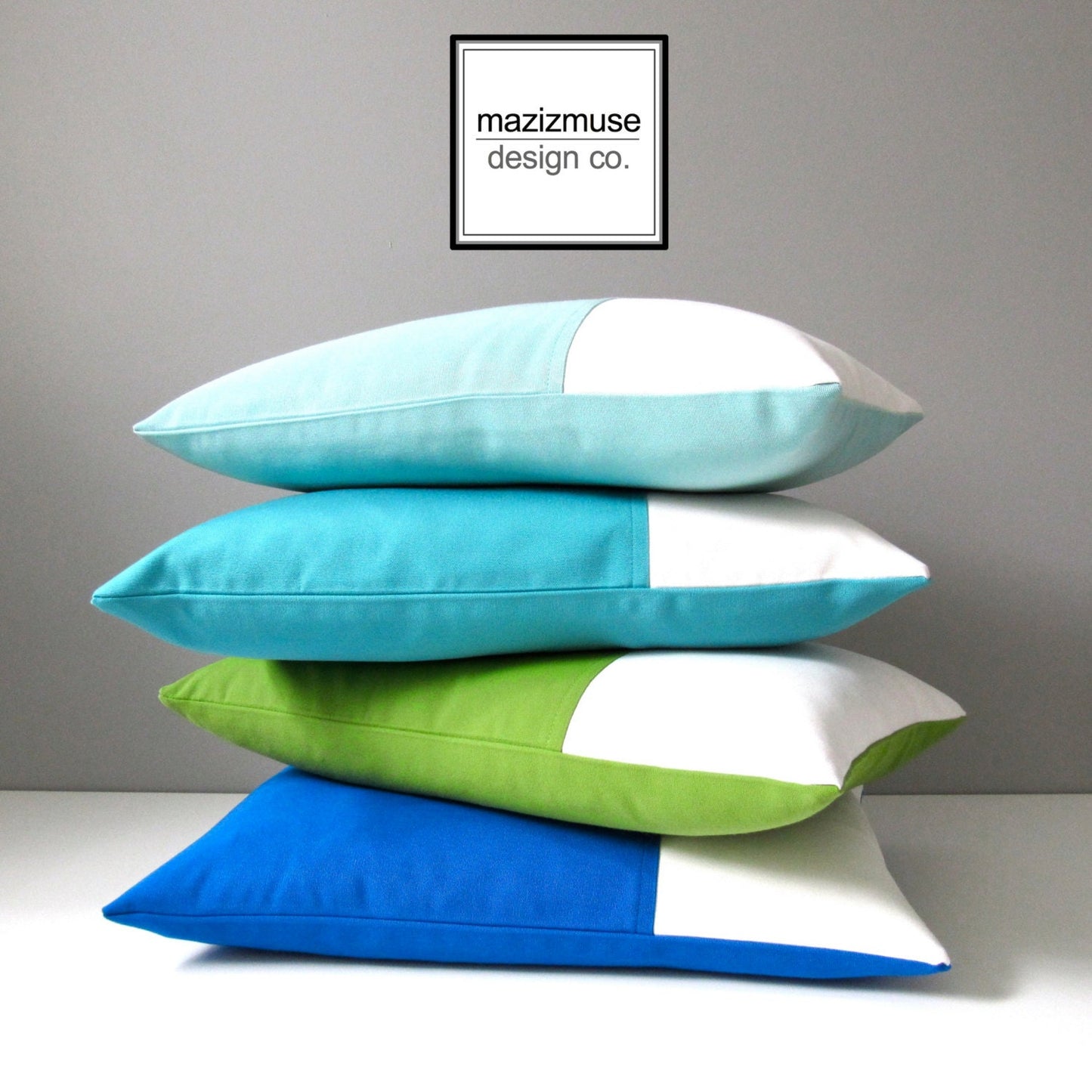 decorative sunbrella outdoor pillows in blues green and white colorblock design by mazizmuse