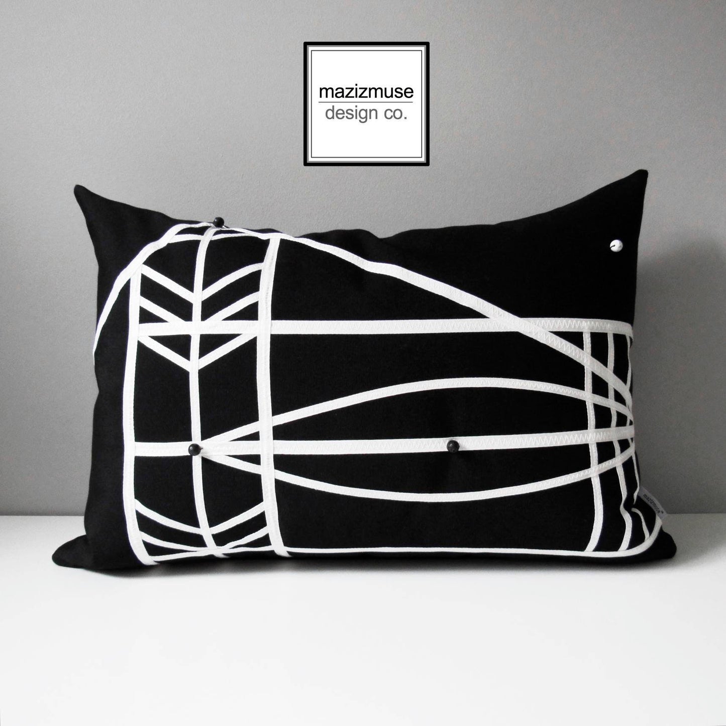 modern black and white outdoor pillow with trim detail and beading. inspired by micronesian explorers' ocean maps