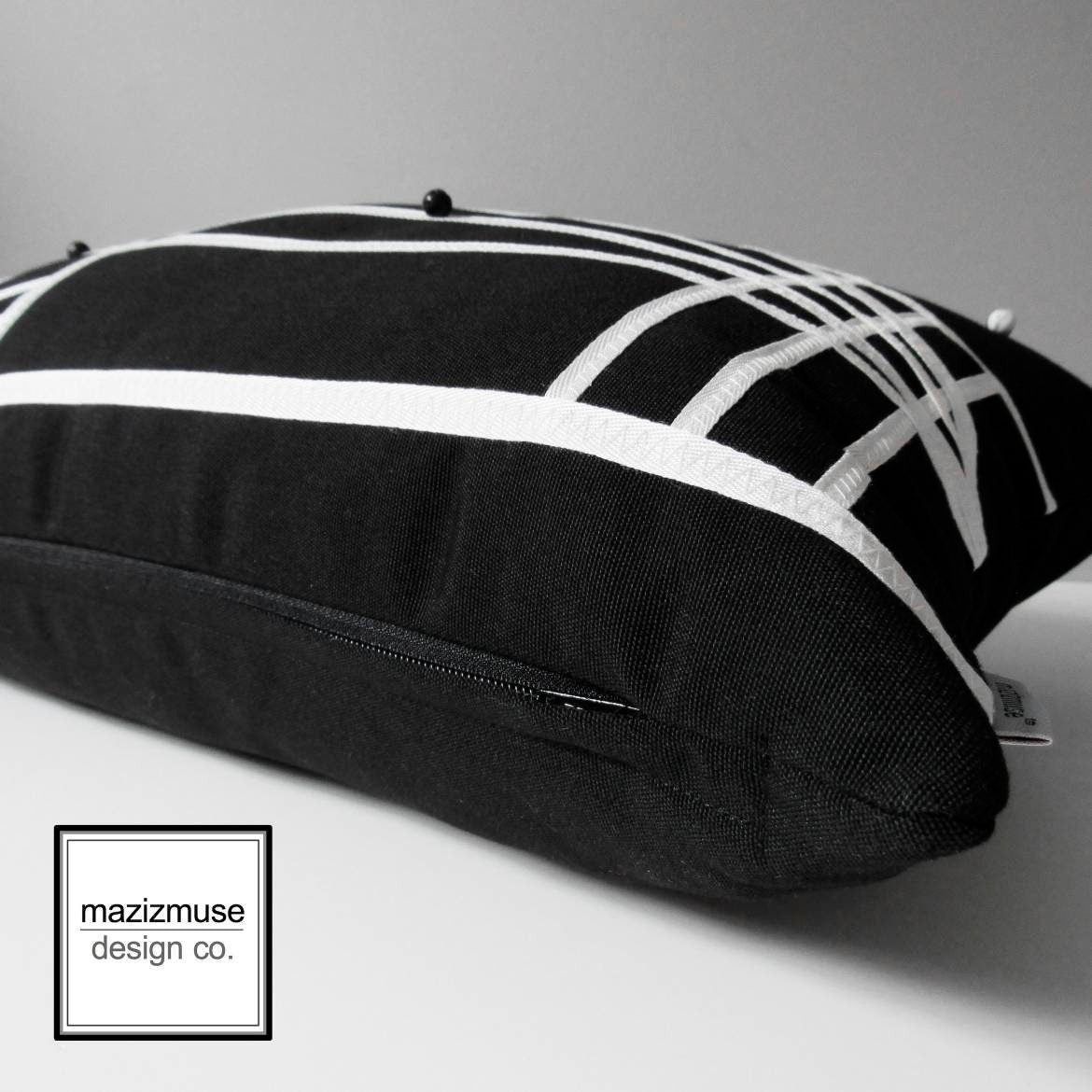 sunbrella outdoor pillow in black with white trim applique. one of a kind!