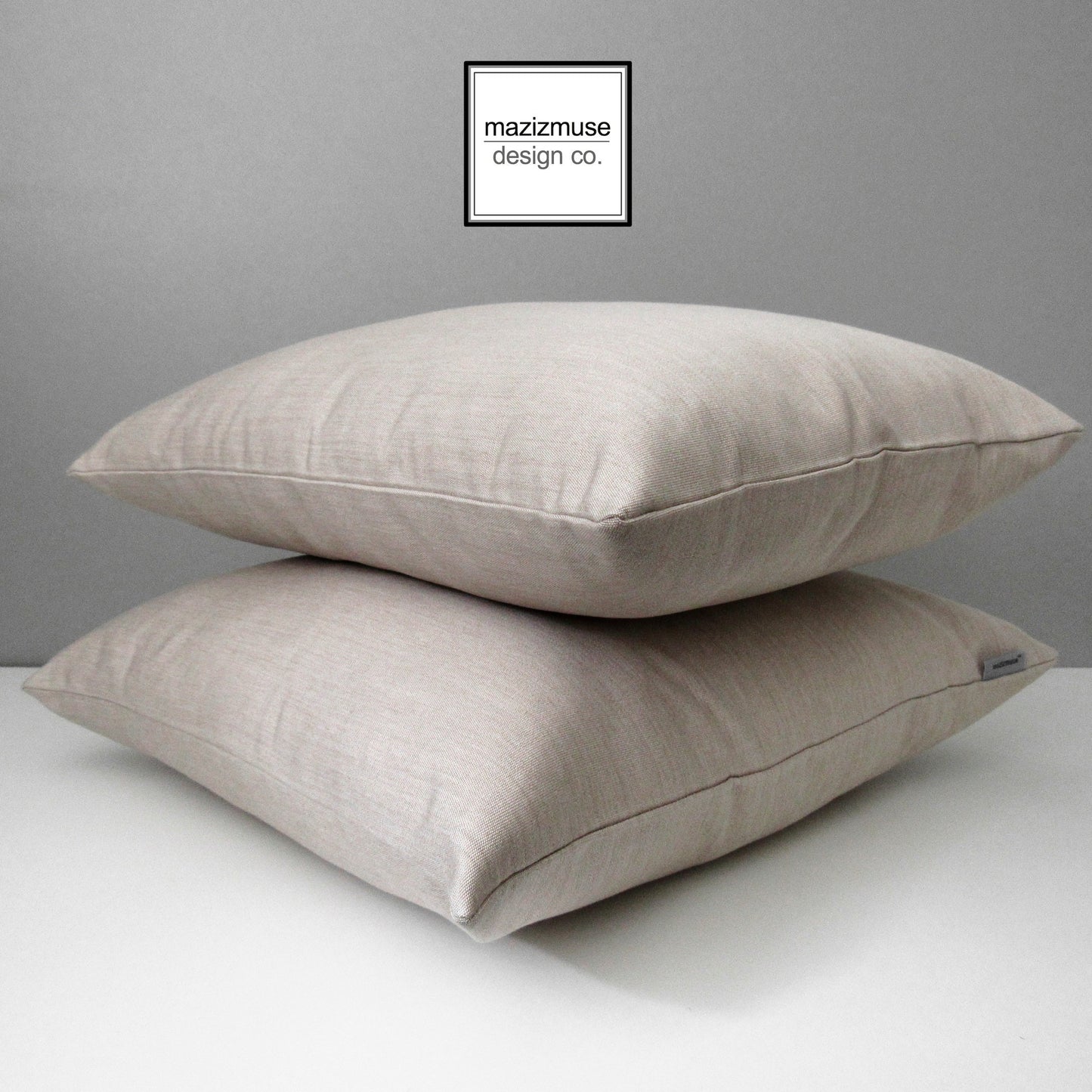 two flax sunbrella outdoor pillow cushions stacked