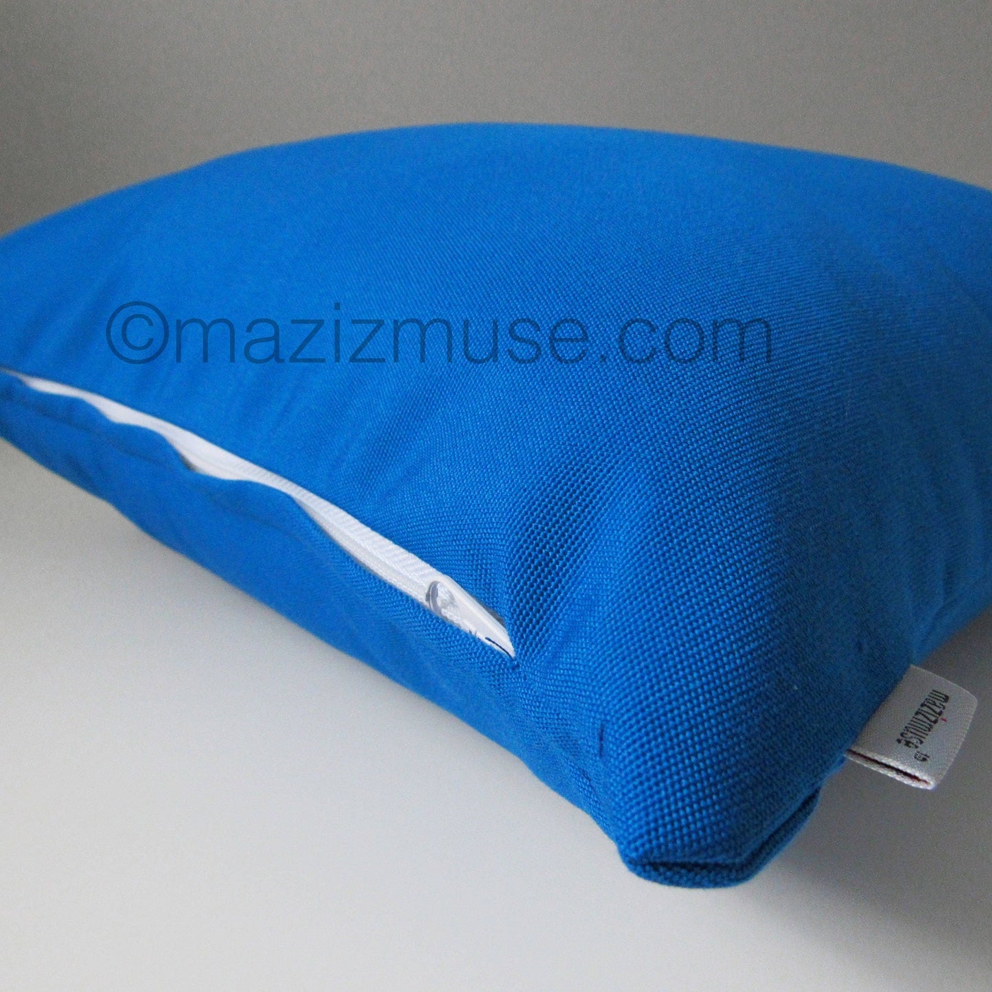 cobalt blue sunbrella outdoor pillow showing zipper detail