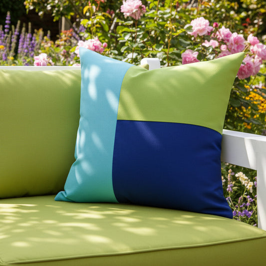 Color-blocked pillow with turquoise, green, and blue sections on a neutral background