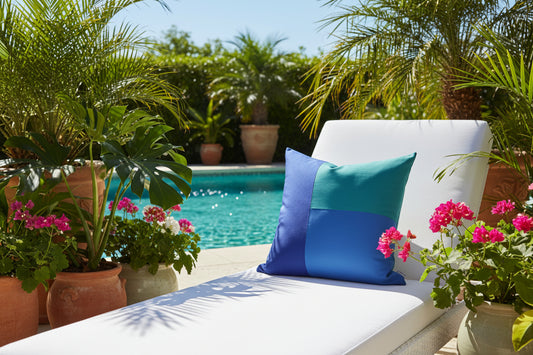 Blue and teal pillow on a white surface with a gray background