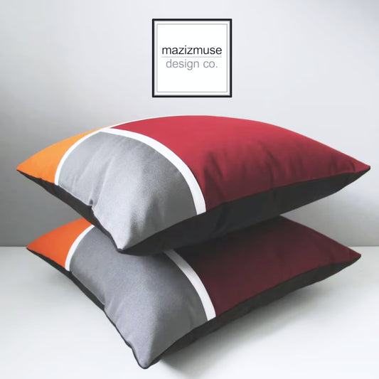 mid century modern outdoor pillow cover in color block design featuring white trim detail.