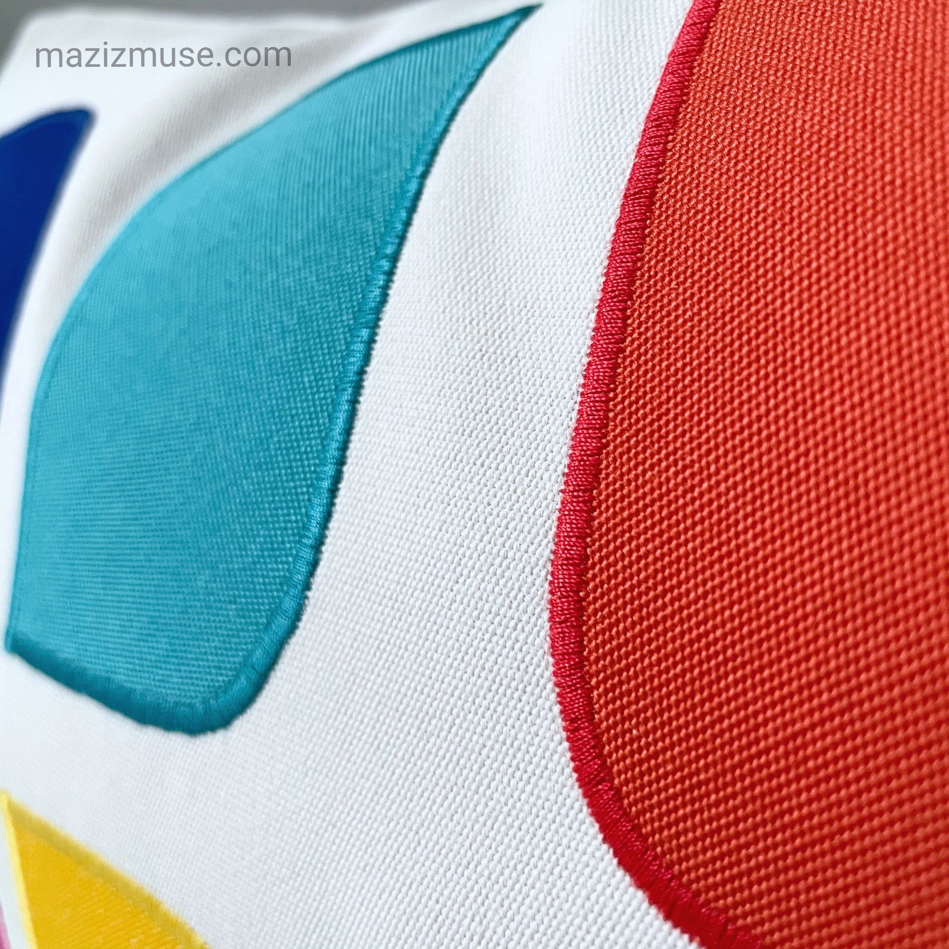 Close-up of a colorful fabric with red, blue, and yellow sections.