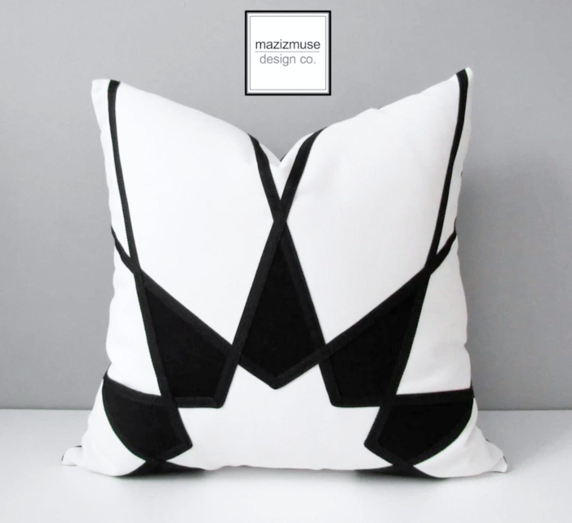 black and white outdoor sunbrella pillow cover with modern mandala design. decorative starburst cushion