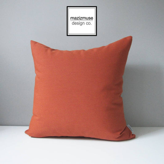 solid burnt orange outdoor pillow cover in sunbrella fabric for unrivaled fade & stain resistance