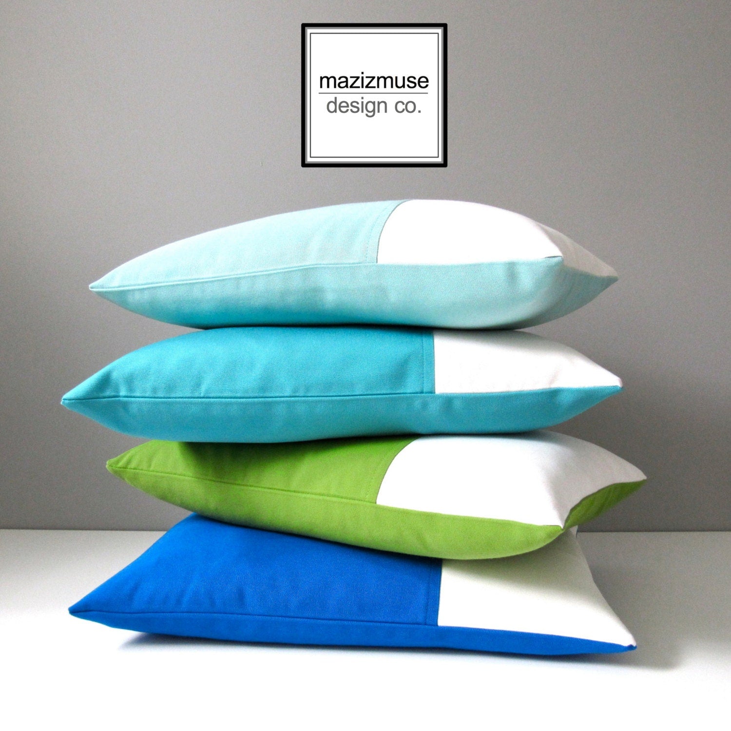 decorative sunbrella outdoor pillows in blues green and white colorblock design by mazizmuse