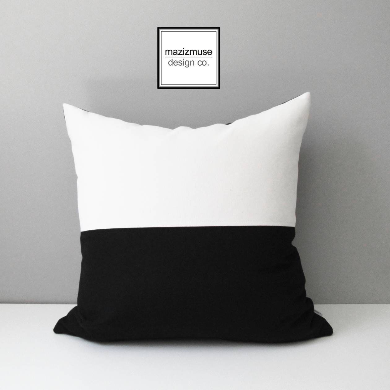 modern black and white colorblock outdoor pillow crafted in sunbrella fabric by mazizmuse