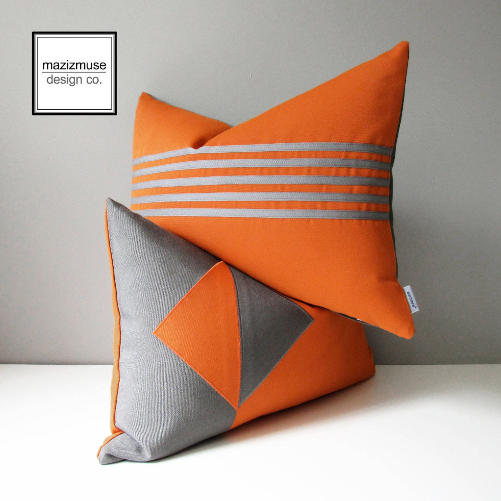 stack of two tuscan orange outdoor pillows in a striped design and geometric design, modern cushions for patio pool chairs