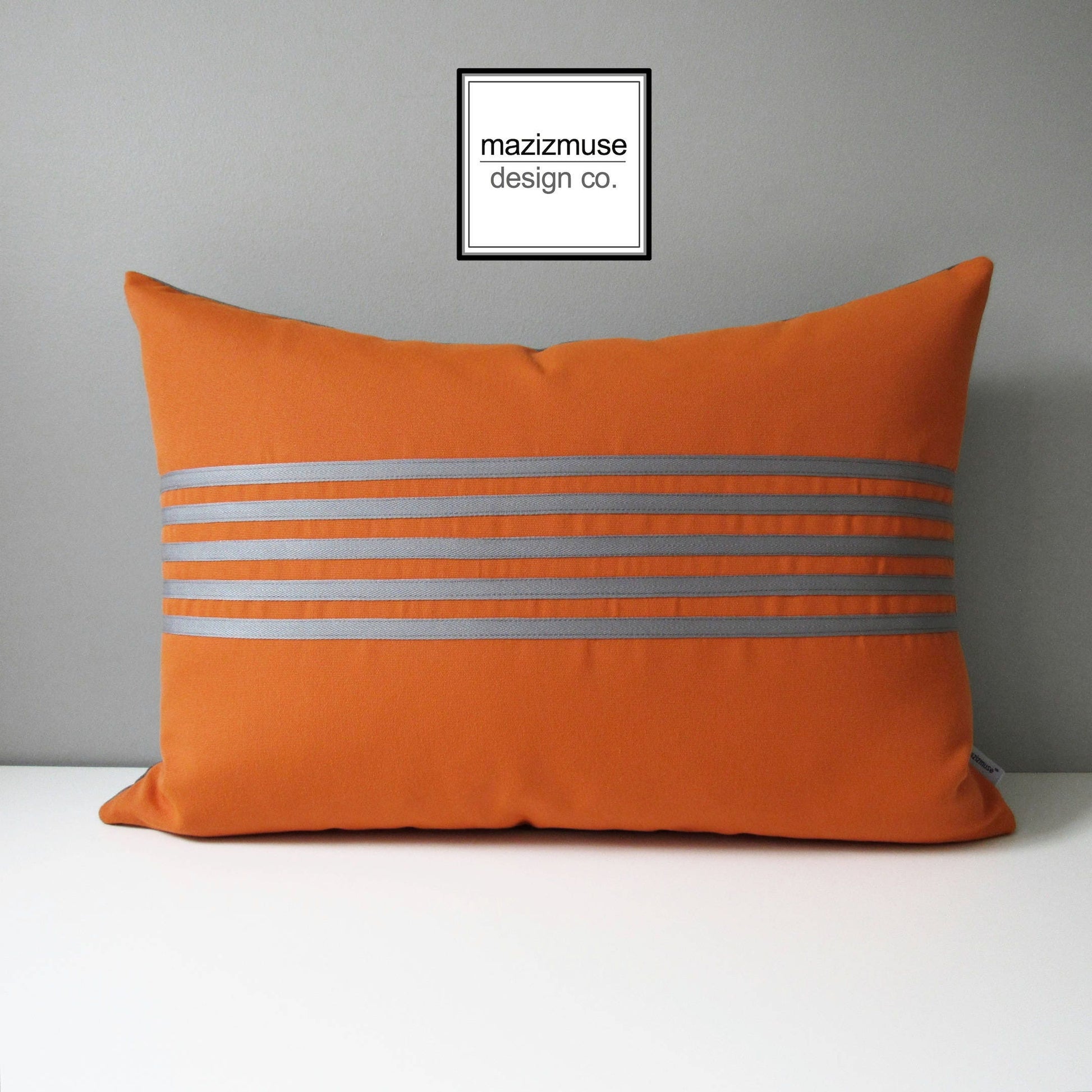 tuscan orange sunbrella pillow with grey trim stripes, outdoor cushions for patio seating